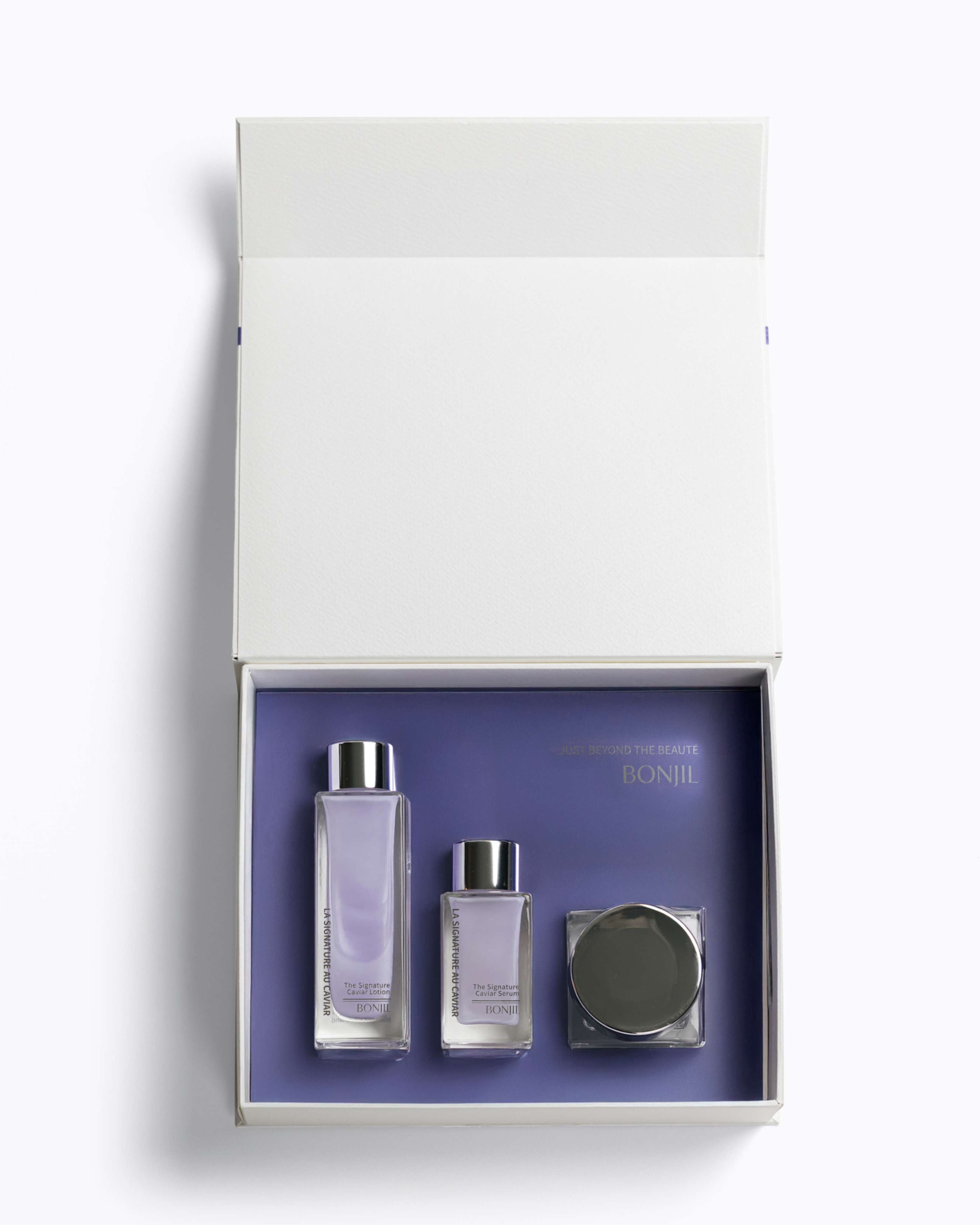 Set of skincare products in a white box with a purple interior